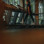 a woman running on a treadmill in a gym