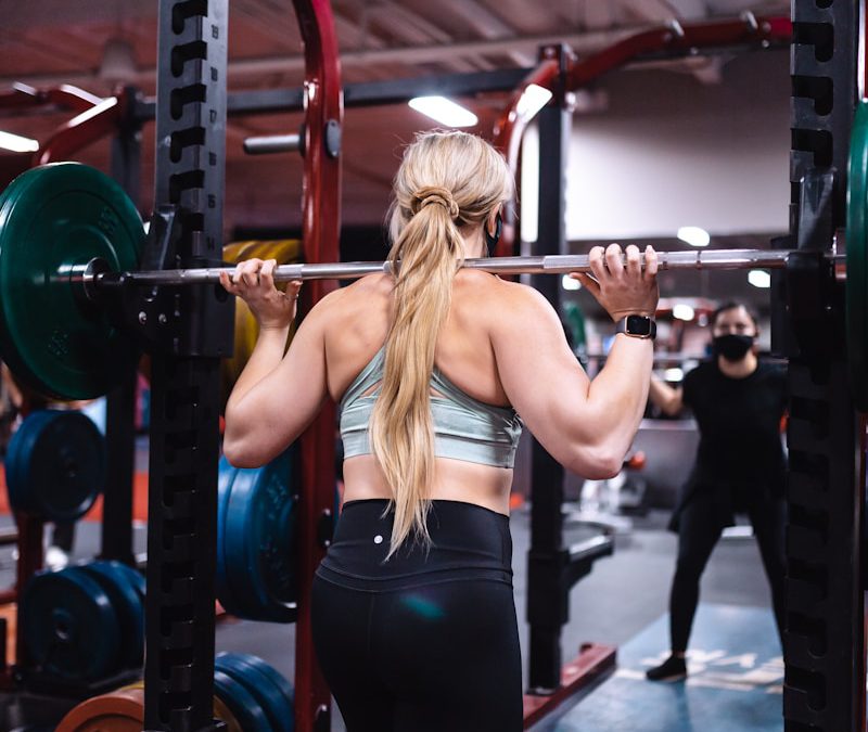 woman in black tank top and black leggings doing exercise