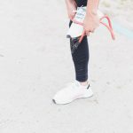 woman in white and black nike sneakers