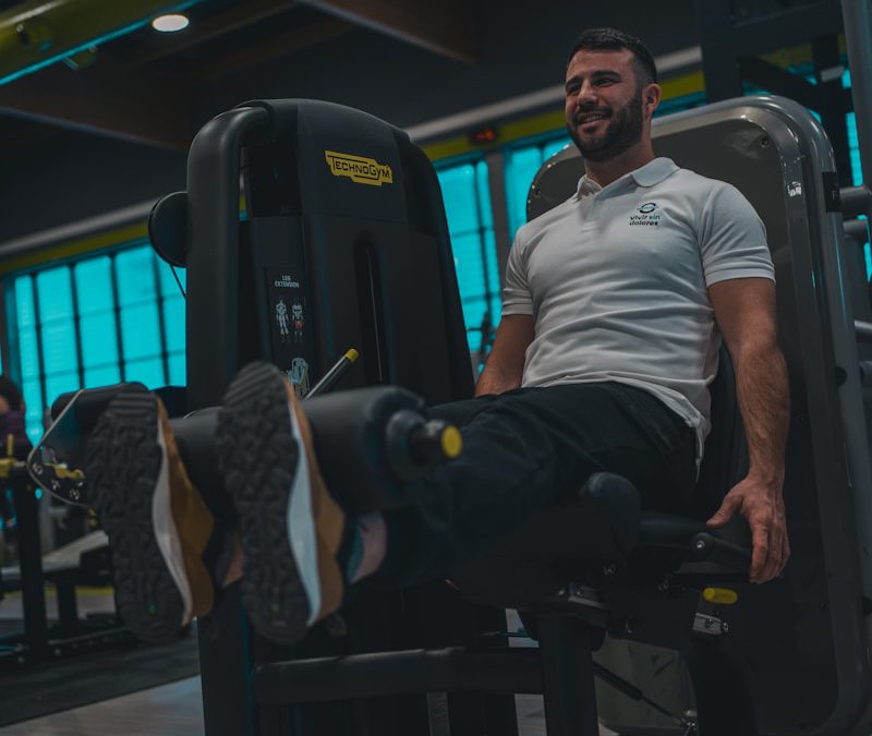 A man sitting on a bench in a gym
